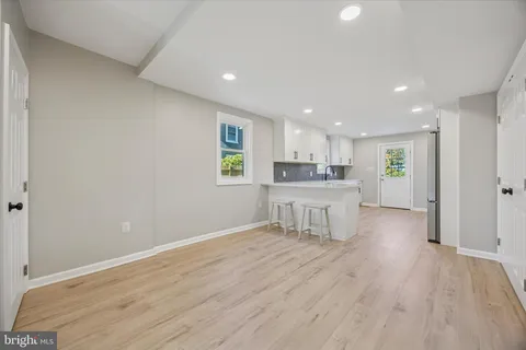 a kitchen with stainless steel appliances granite countertop a white cabinets and wooden floor
