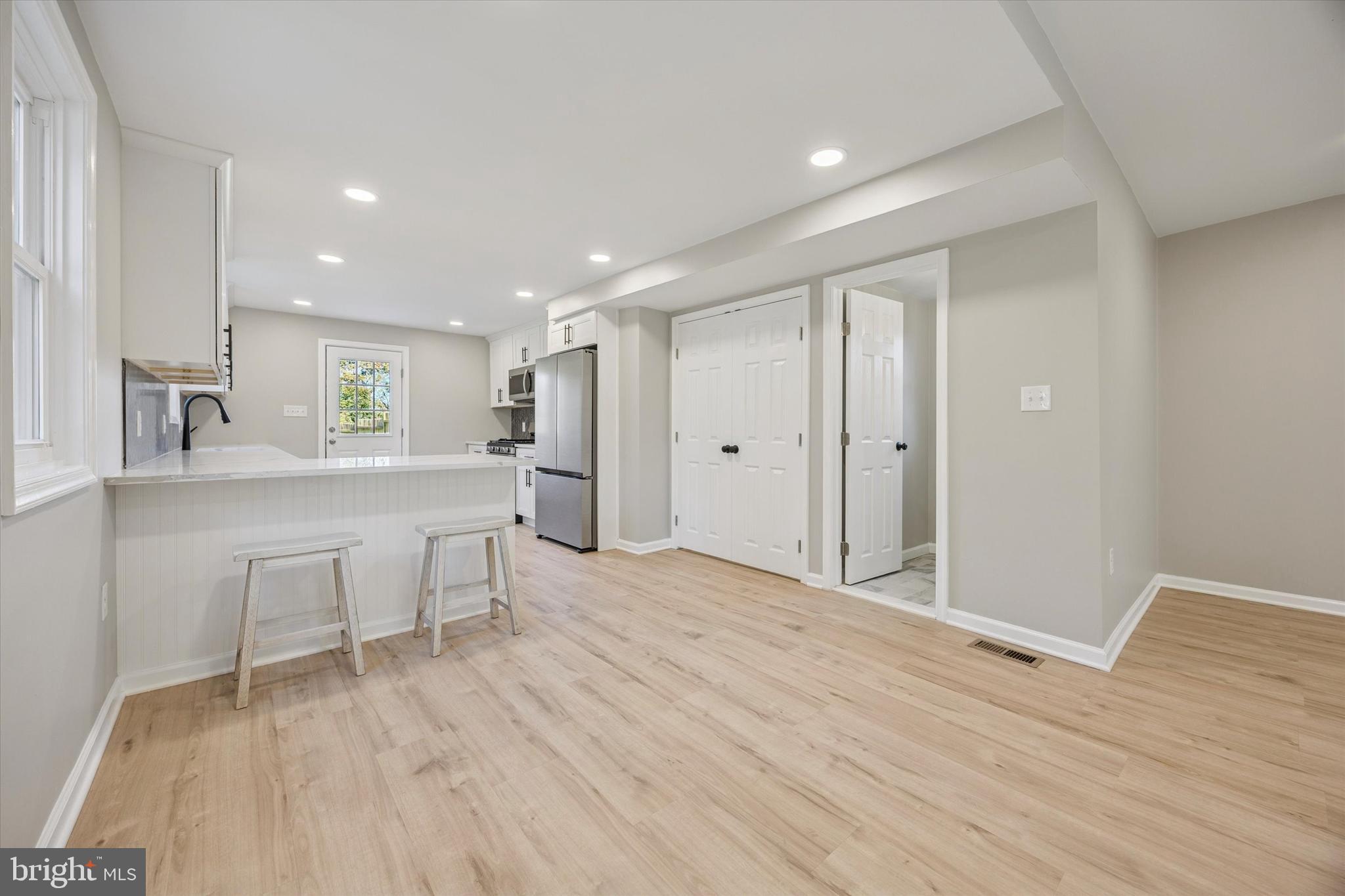 3011 Church Road Lafayette Hill, PA 19444 - Photo 8 of 30 a view of an empty room with kitchen and wooden floor