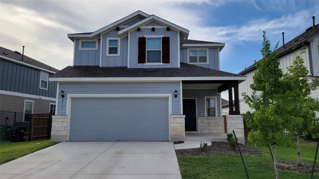 a front view of a house with a garage