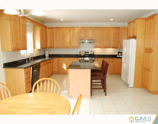 116 Harding Avenue Edison, NJ 08820 - Photo 2 of 10 a kitchen with a refrigerator a stove a sink and a dining table