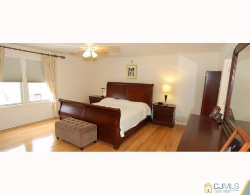 116 Harding Avenue Edison, NJ 08820 - Photo 6 of 10 a bedroom with a bed window and a flat screen tv