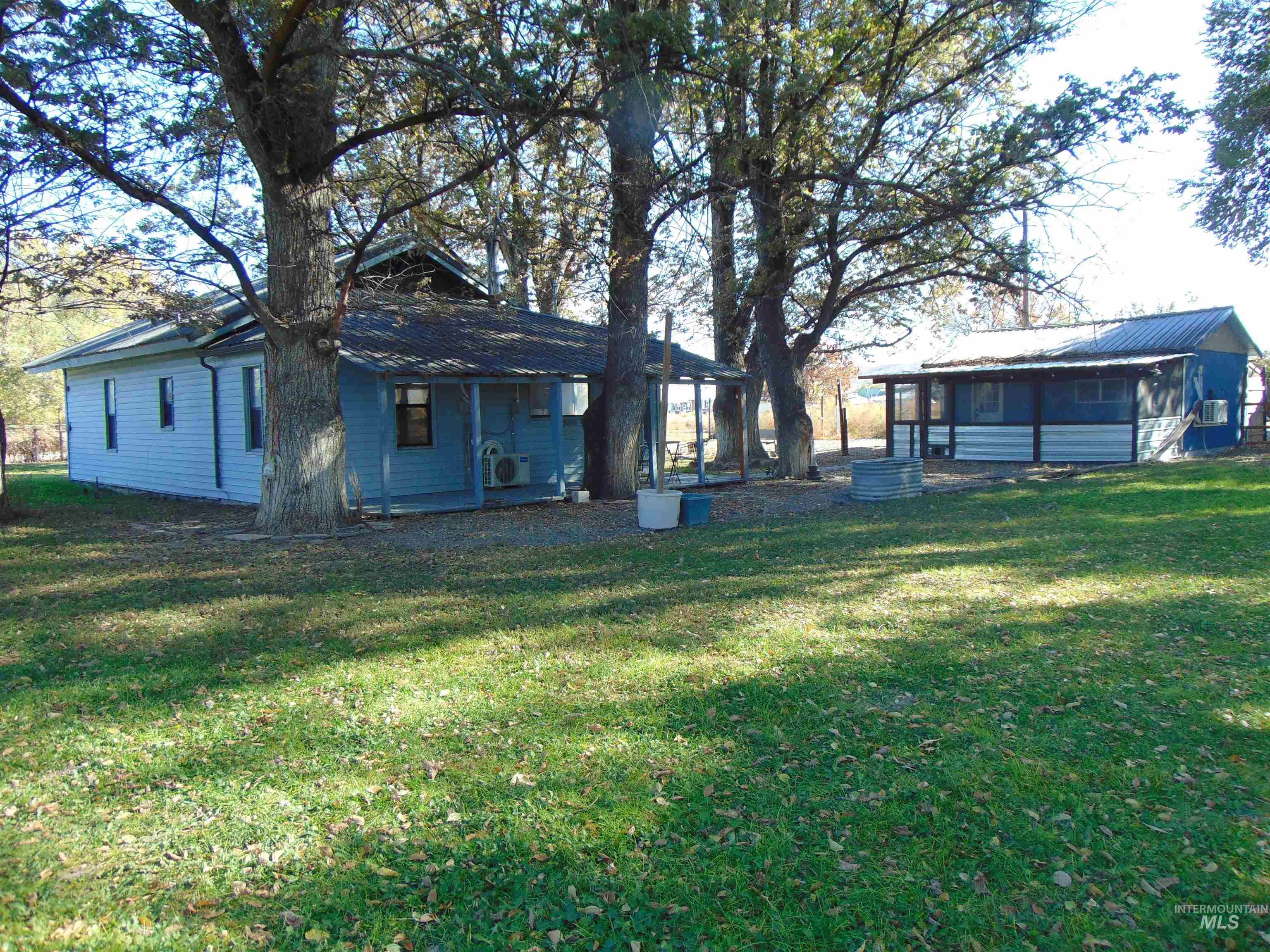 Rear view of property with a lawn and covered porch