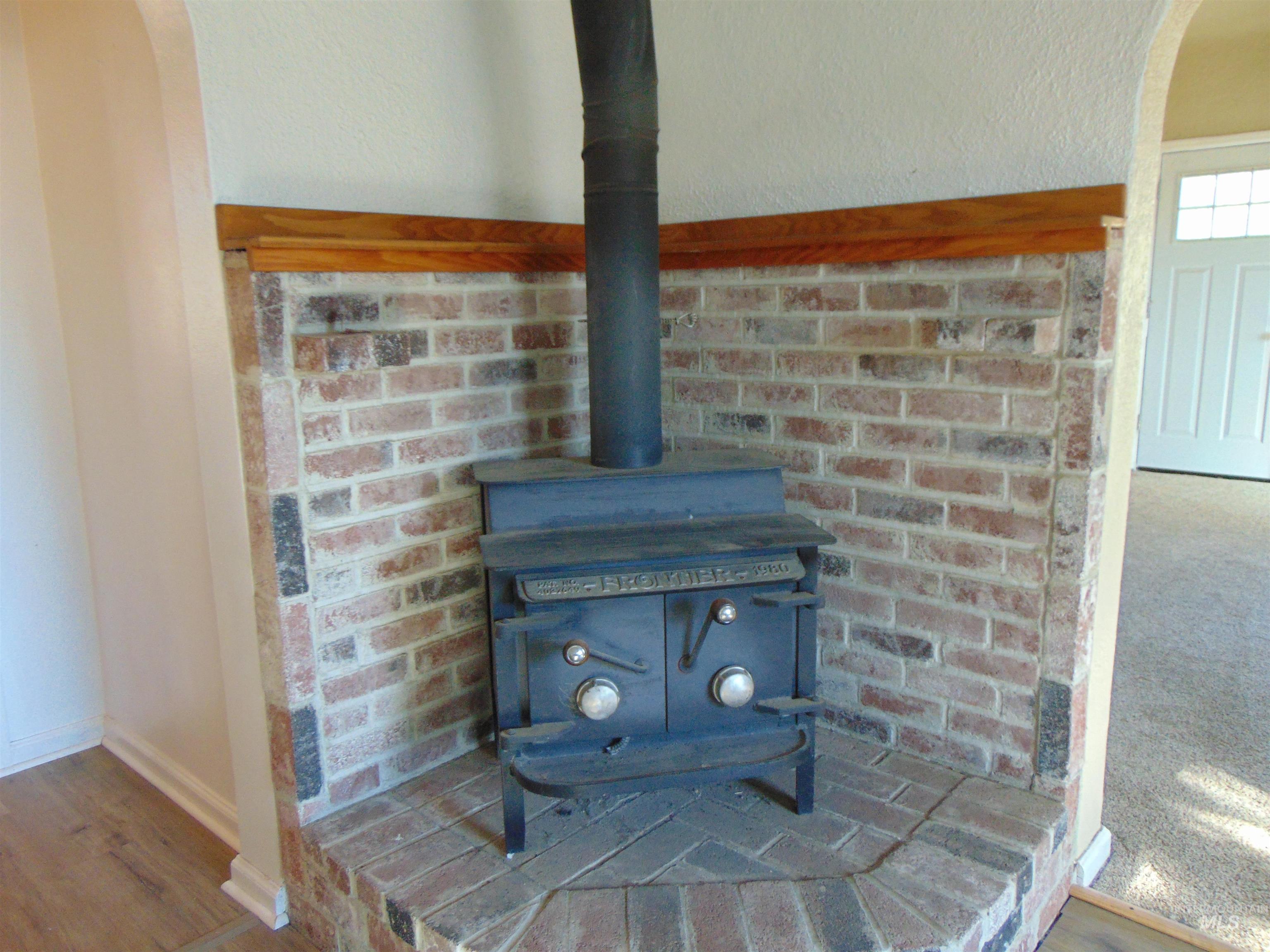 2933 2nd Street Harper, OR 97906 - Photo 11 of 28 Detailed view of arched walkways, a wood stove, and wood finished floors