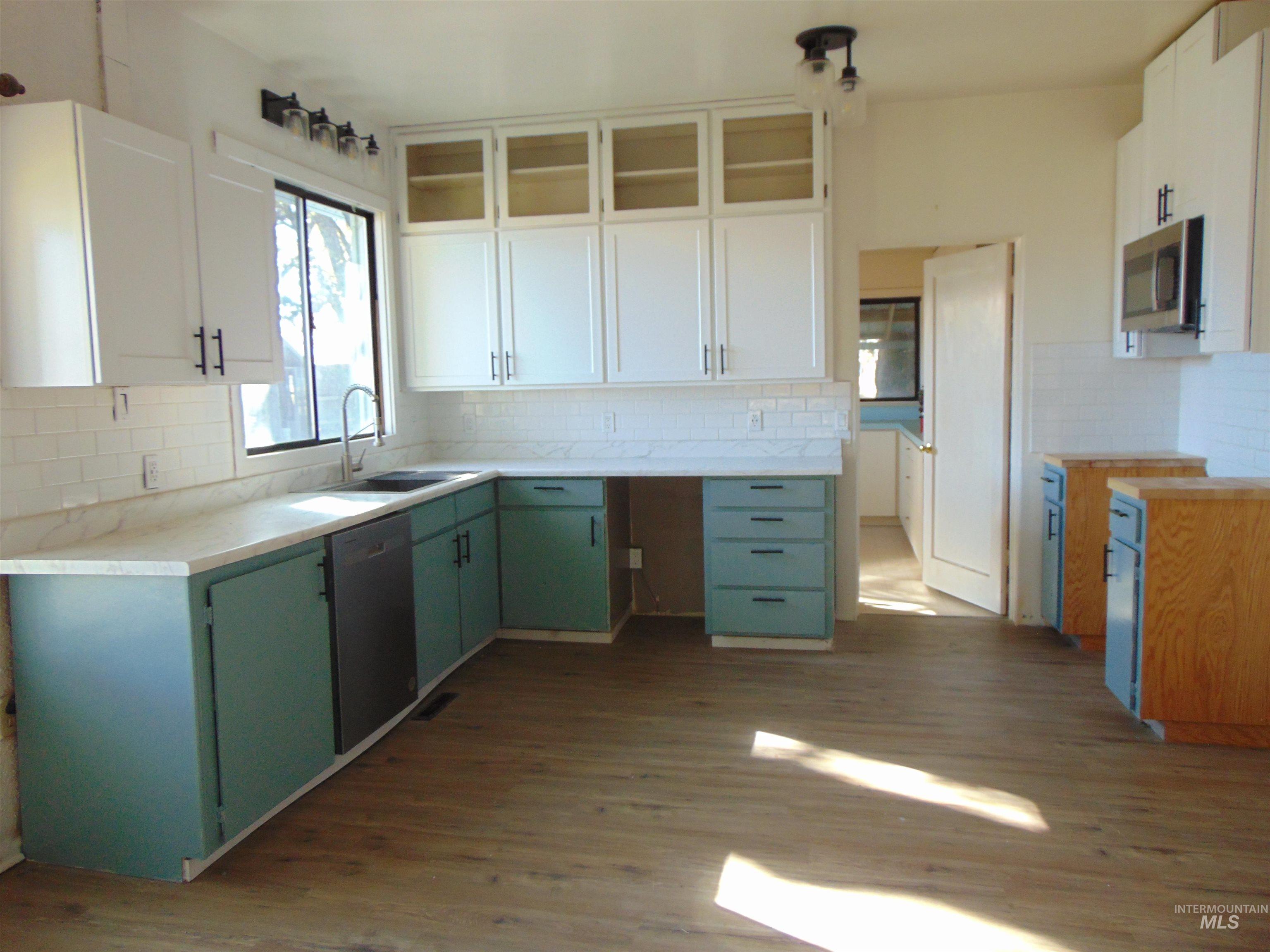 2933 2nd Street Harper, OR 97906 - Photo 13 of 28 Kitchen with green cabinetry, white cabinetry, and dark wood-type flooring