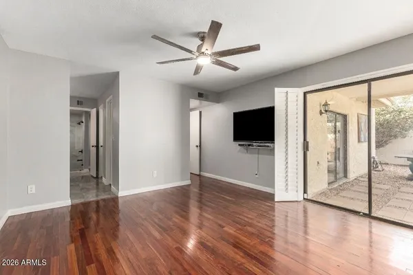 a view of a white house with a yard and potted plants