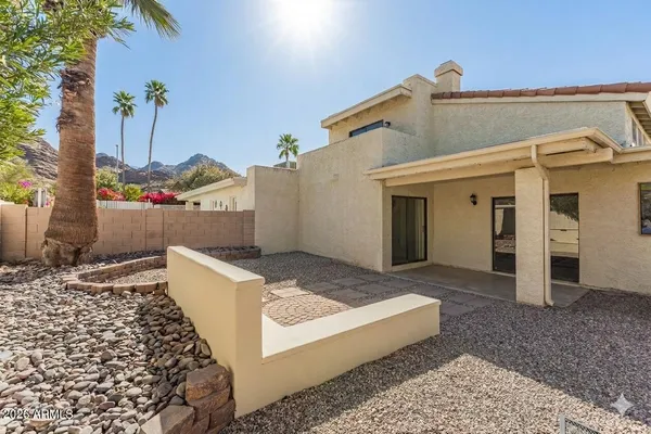 a view of a swimming pool with a lounge chair and tables