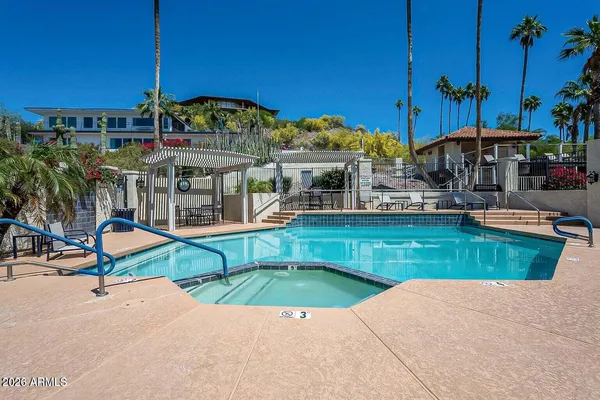 a living room with furniture a fireplace and a floor to ceiling window