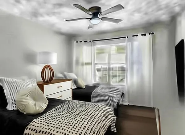 a view of a room with wooden floor and a ceiling fan