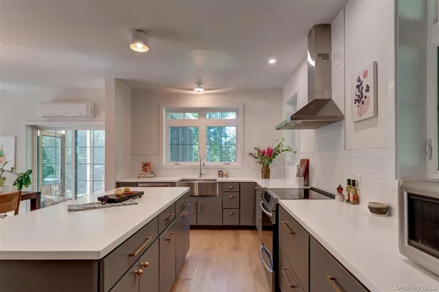 a kitchen with a sink stove and cabinets