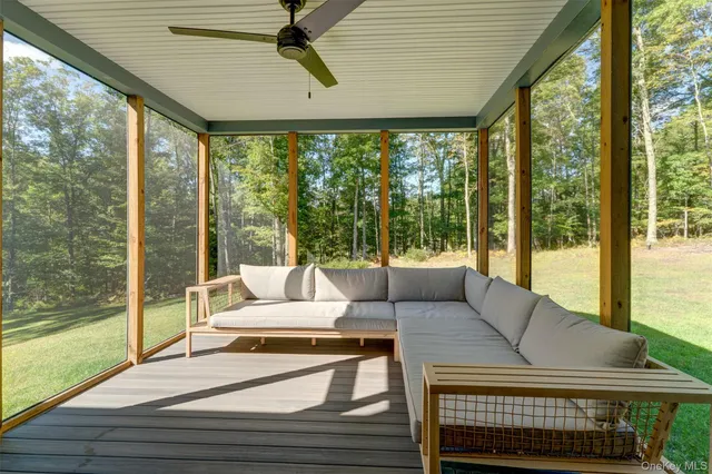 a living room with furniture and a floor to ceiling window