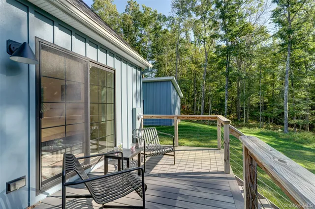 a view of house with backyard and deck