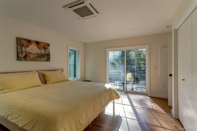 a large bed sitting in a bedroom next to a window