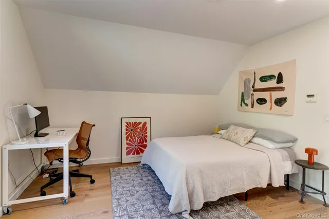 a bedroom with a bed and a desk