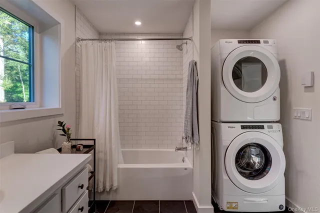 a bathroom with a sink a washer and dryer