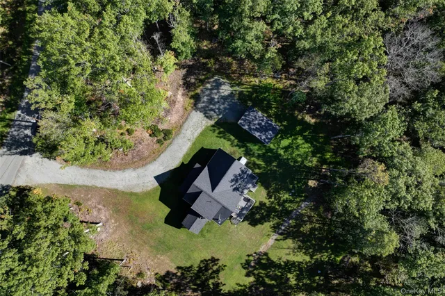 an aerial view of a house with a yard