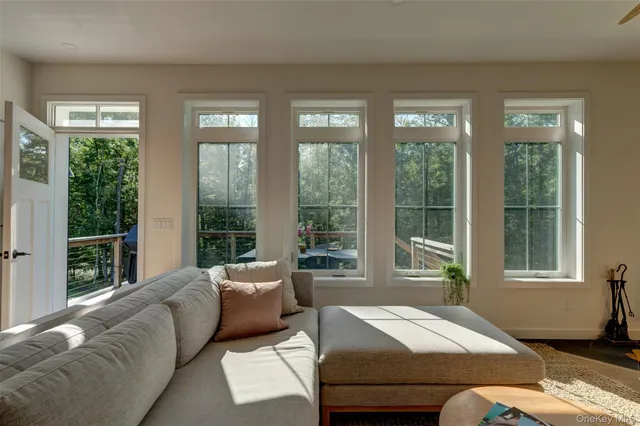 a bedroom with furniture and large windows
