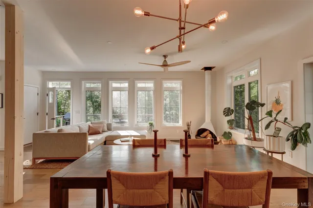 a view of a dining room with furniture large windows and wooden floor