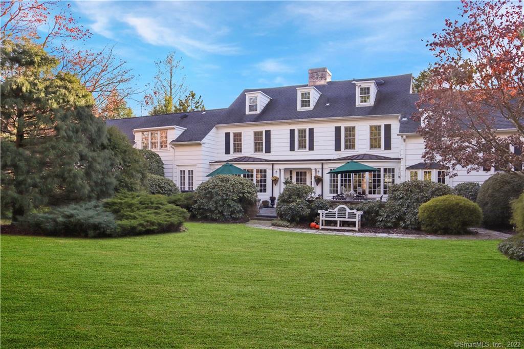 Beautiful rolling lawns with a view of the back of the house.