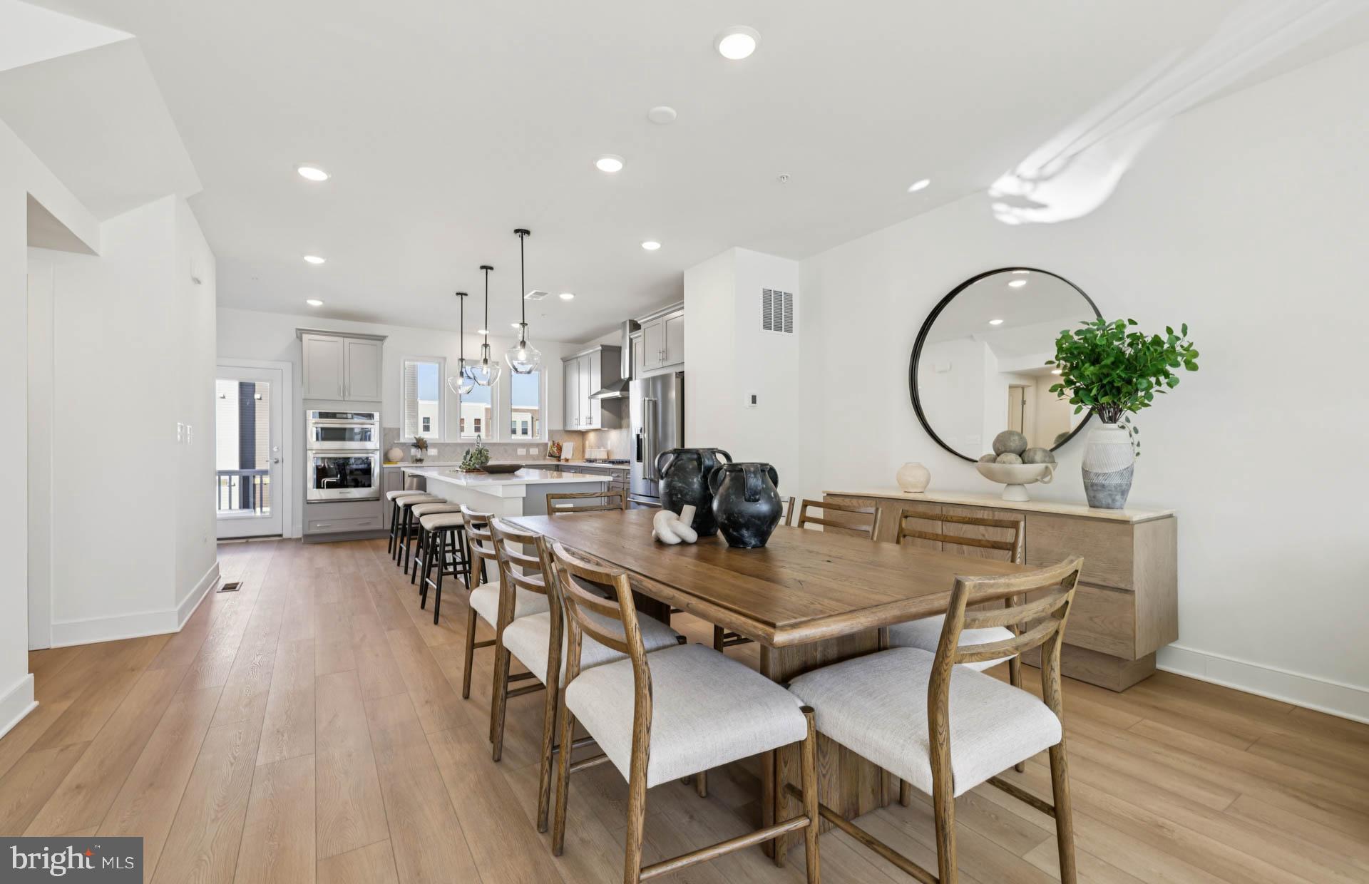 4716 Bellrock Alley Boyds, MD 20841 - Photo 7 of 47 a view of a dining room with furniture and wooden floor