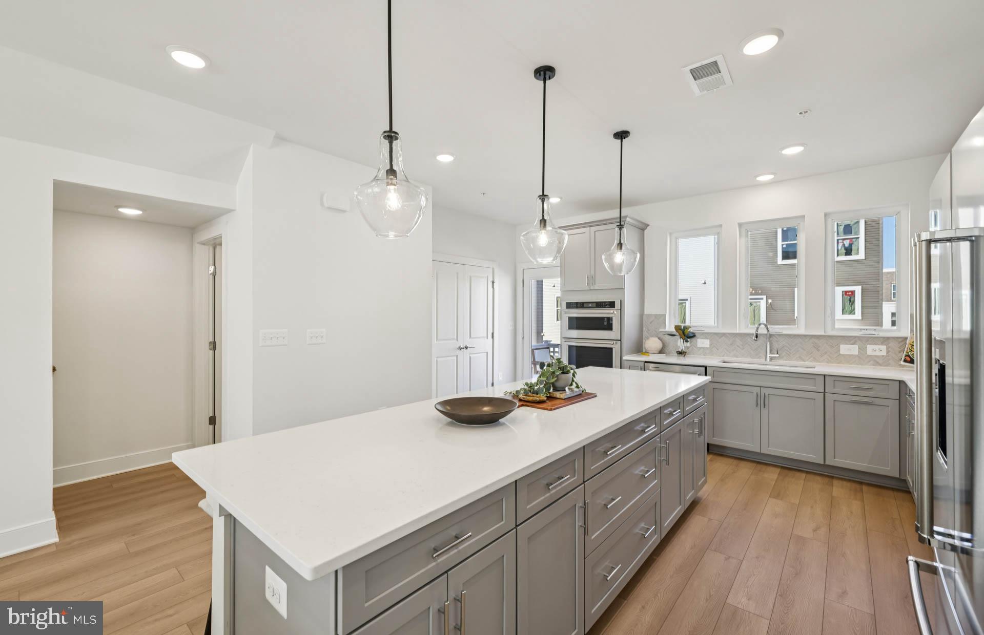 4716 Bellrock Alley Boyds, MD 20841 - Photo 9 of 47 a kitchen with a sink stove and wooden floor