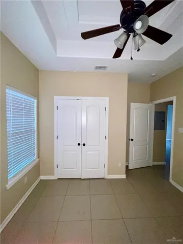 a bathroom with a granite countertop sink mirror vanity and toilet