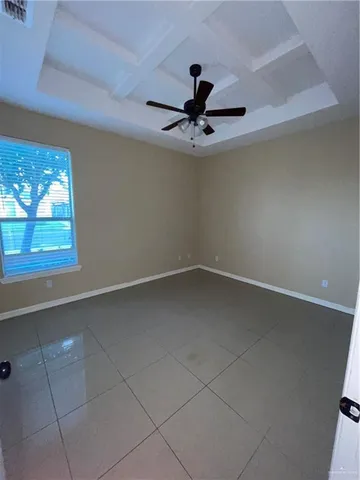 a view of a livingroom with a ceiling fan and window