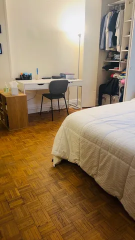 a bedroom with a bed and a bookshelf