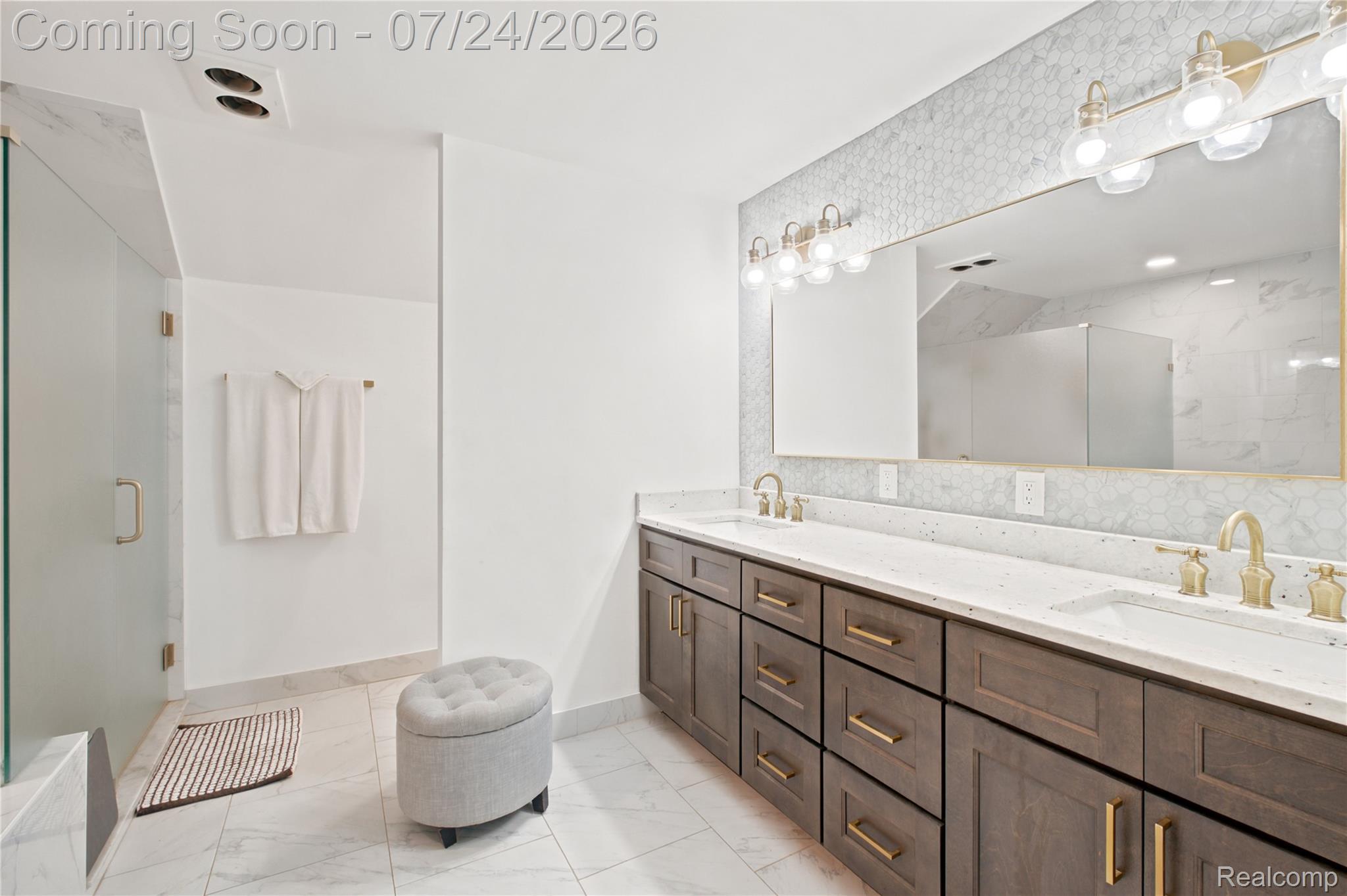 377 Ridgemont Road Oxford, MI 48370 - Photo 30 of 52 Dual vanity featuring wood-finish cabinetry with brass hardware, solid surface countertops, and under-mount sinks
