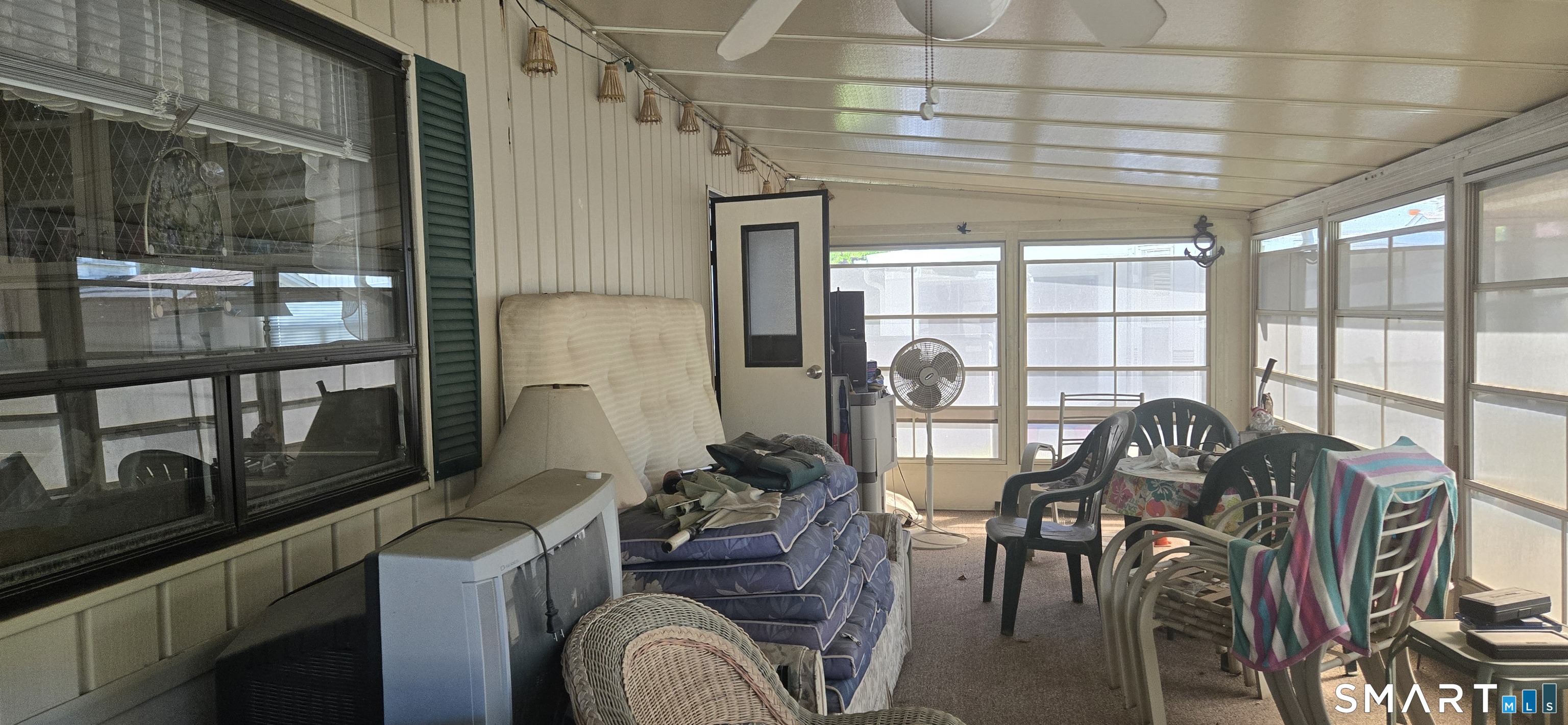 306 Old Colchester Road, Unit 126 Salem, CT 06420 - Photo 11 of 22 a room with furniture a chandelier and a window