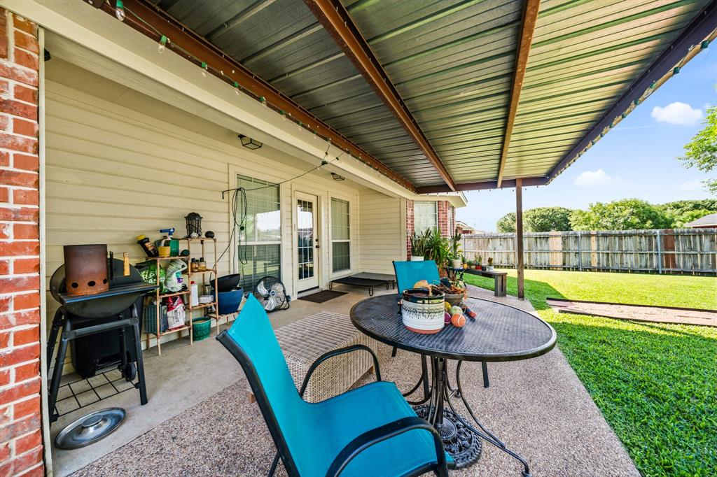 10512 Whitney Trace Drive Waco, TX 76708 - Photo 5 of 39 Covered patio space featuring a corrugated metal roof and exposed support beams
