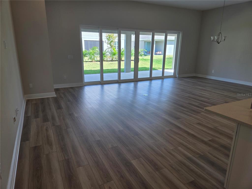 5178 Everlong Drive Apollo Beach, FL 33572 - Photo 15 of 25 a view of an empty room with wooden floor and a window