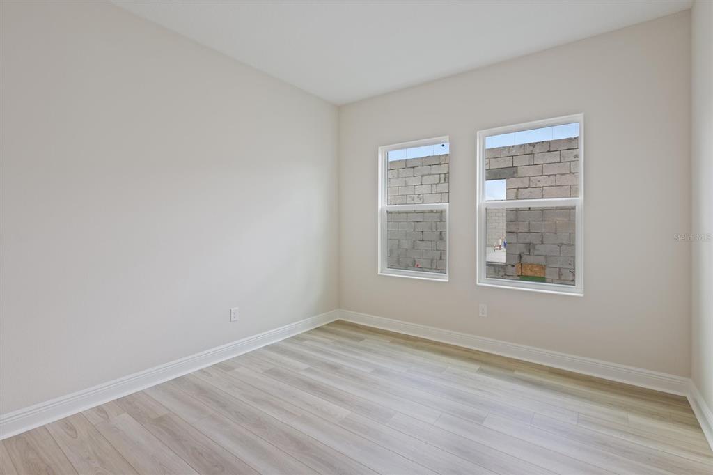5178 Everlong Drive Apollo Beach, FL 33572 - Photo 20 of 25 an empty room with wooden floor and windows