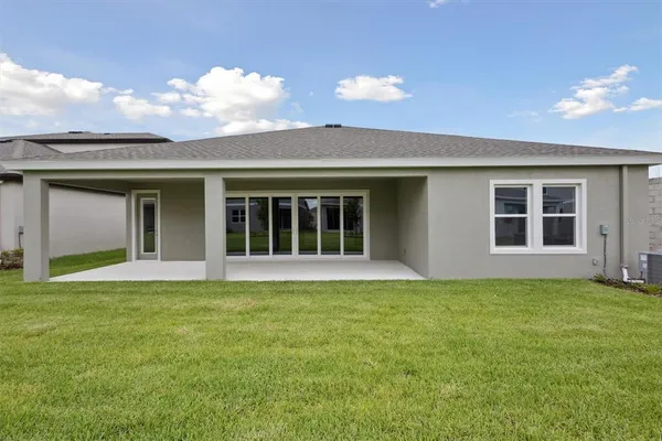 a view of an house with backyard space and garden