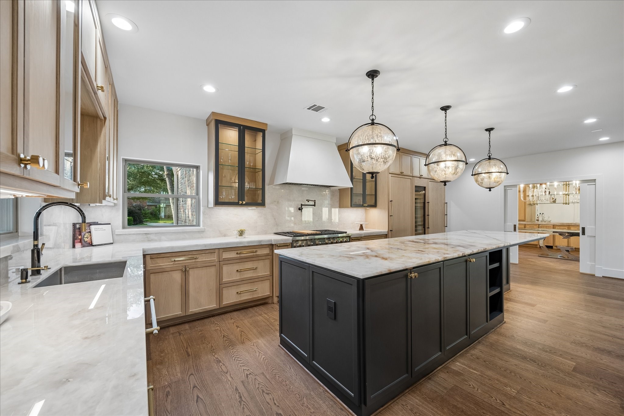 620 Stoneleigh Drive Houston, TX 77079 - Photo 12 of 39 A commanding view of the kitchen showcases a Wolf 6-burner gas range with double ovens, set against an expanse of generous counter space ideal for both prep and serving. Designed to impress at every turn, this kitchen is truly a showstopper.