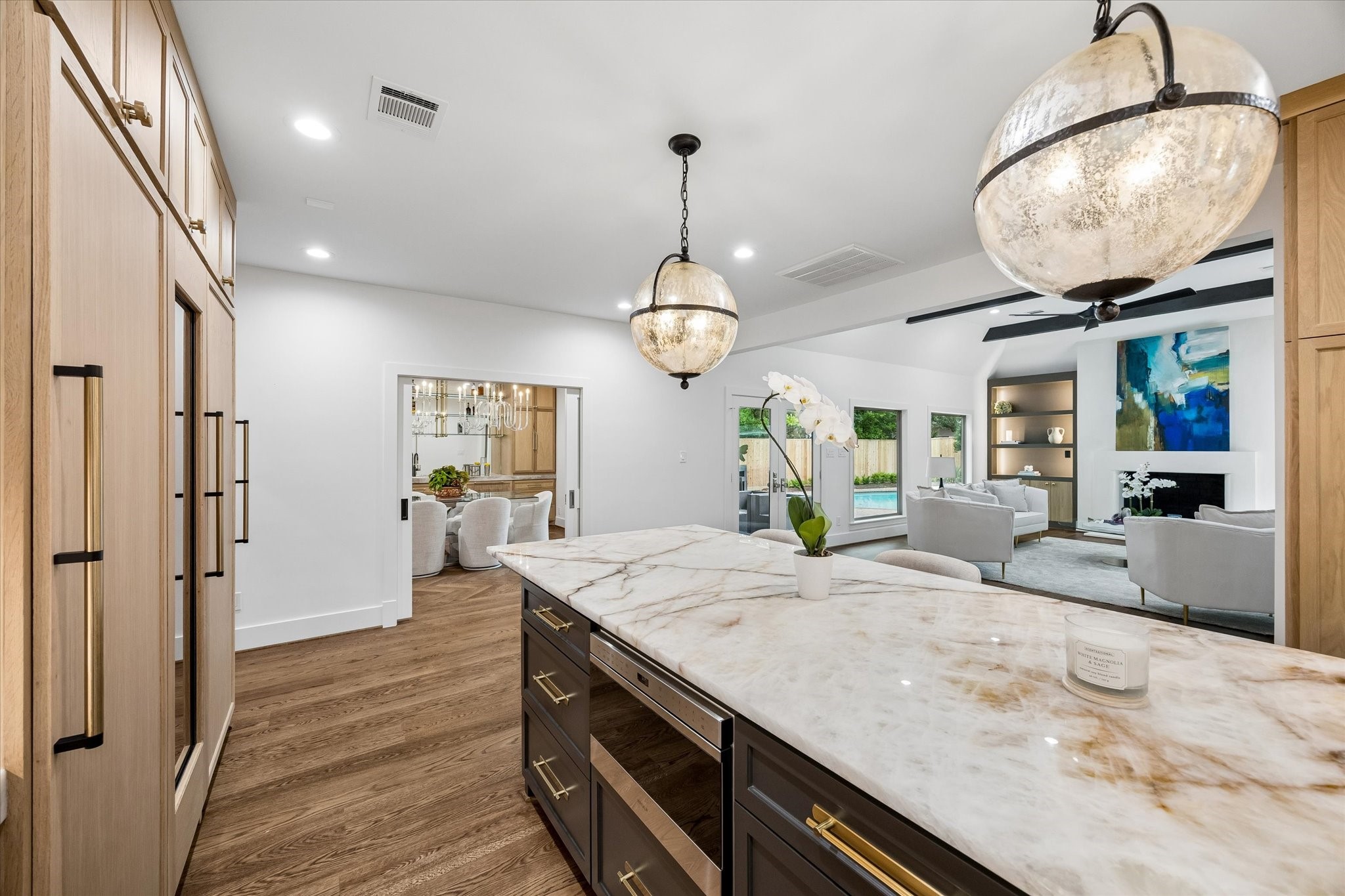 620 Stoneleigh Drive Houston, TX 77079 - Photo 14 of 39 At the heart of the kitchen sits a massive island designed for both function and gathering, featuring abundant drawer storage and expansive prep space. Topped with Crystallo Fire Quartzite with a laminated edge, and offering generous island seating, it creates the perfect spot for casual dining, conversation, and staying connected while meals come together.