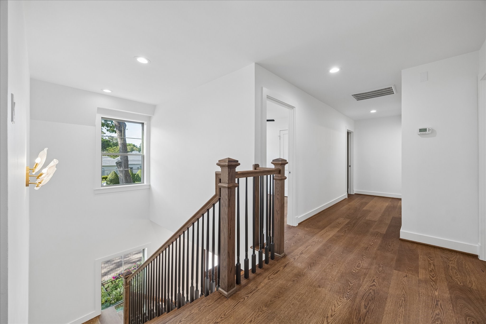 620 Stoneleigh Drive Houston, TX 77079 - Photo 22 of 39 Upstairs landing offers an open, airy feel with a clear view below, creating a sense of connection between levels and a light-filled transition space.