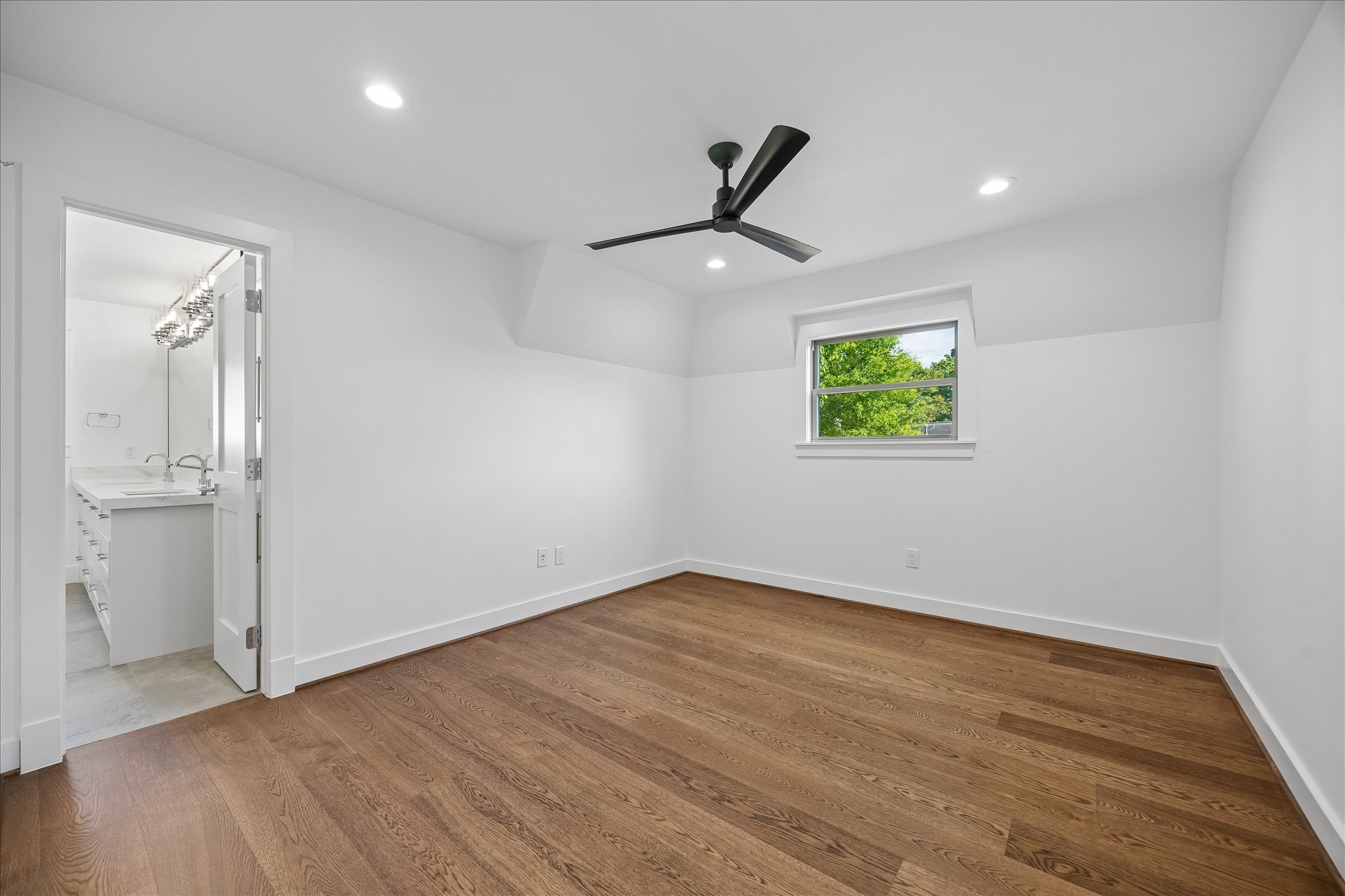 620 Stoneleigh Drive Houston, TX 77079 - Photo 24 of 39 Generously sized secondary bedroom filled with natural light, complemented by a custom-built closet with tailored storage solutions