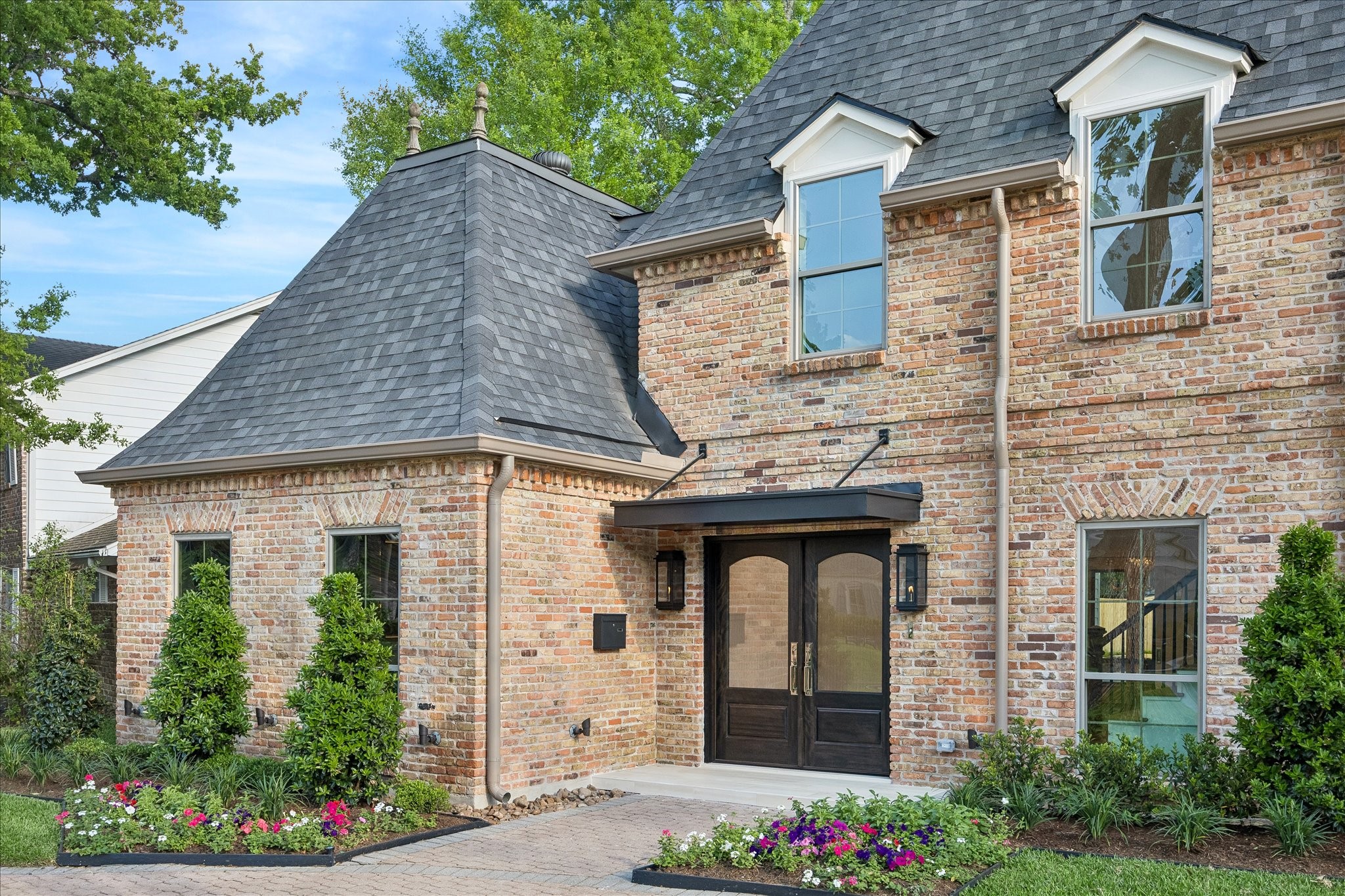 620 Stoneleigh Drive Houston, TX 77079 - Photo 3 of 39 Coming up the walkway, you are drawn toward the inviting front porch. Newly added mature landscaping, adorned with cheerful blooms, creates a fresh and welcoming approach for guests.