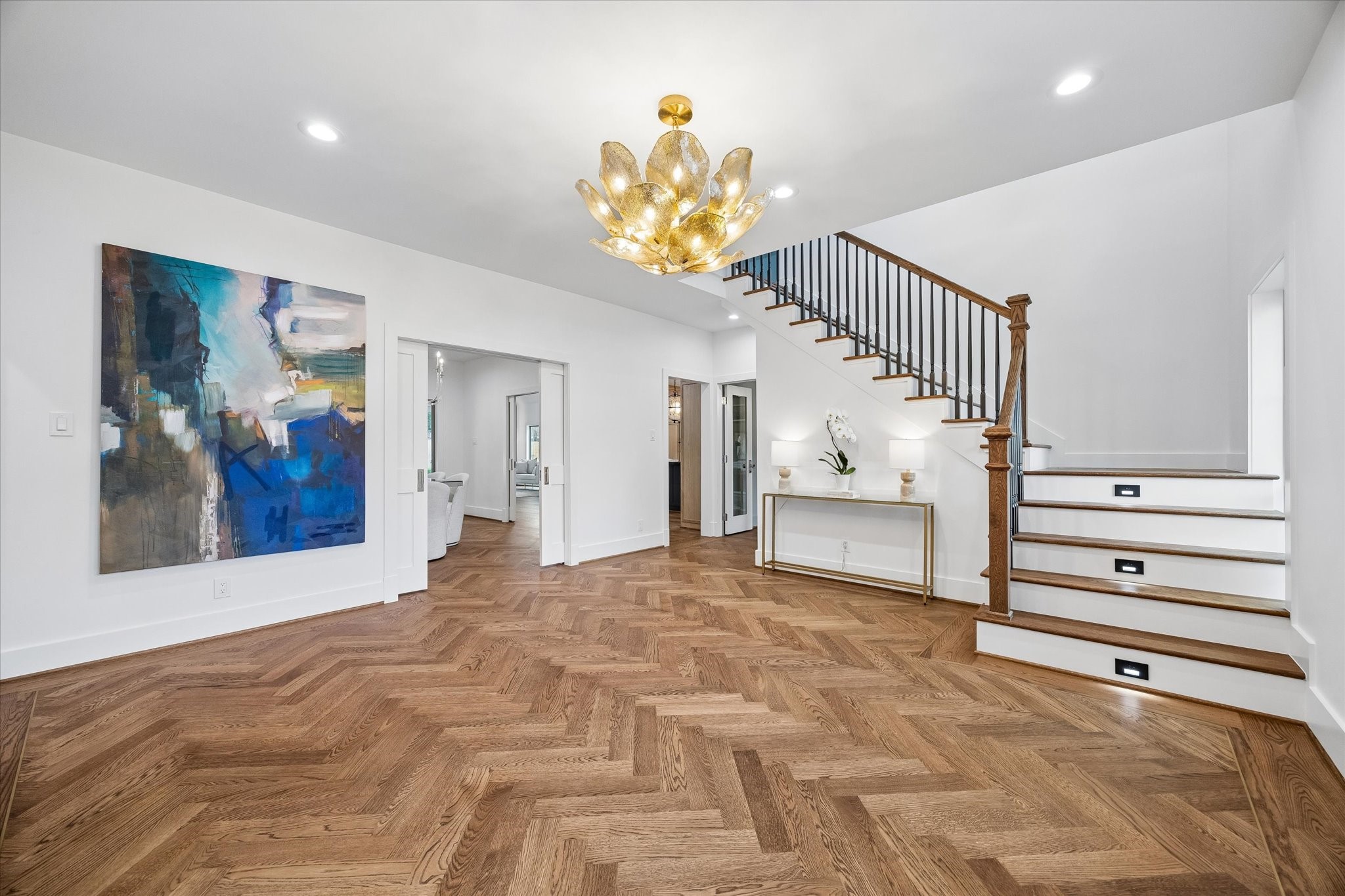 620 Stoneleigh Drive Houston, TX 77079 - Photo 4 of 39 Stepping into the gracious foyer, rich oak hardwood floors trimmed in brass set a refined and sophisticated tone. This beautifully appointed space connects to the study, formal dining room and kitchen, offering an elegant and welcoming introduction to the home.