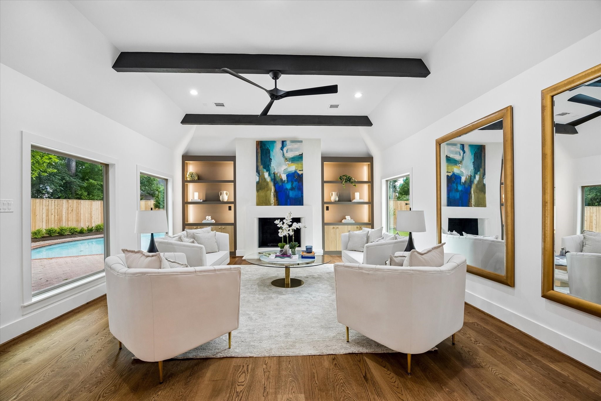 620 Stoneleigh Drive Houston, TX 77079 - Photo 8 of 39 The open living space is highlighted by a designer ceiling fan by Torque, perfectly complementing the clean lines and architectural beams above. Natural light pours in, while the fireplace and surrounding details create a warm and inviting setting.