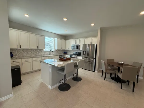 a kitchen with a sink cabinets and stainless steel appliances