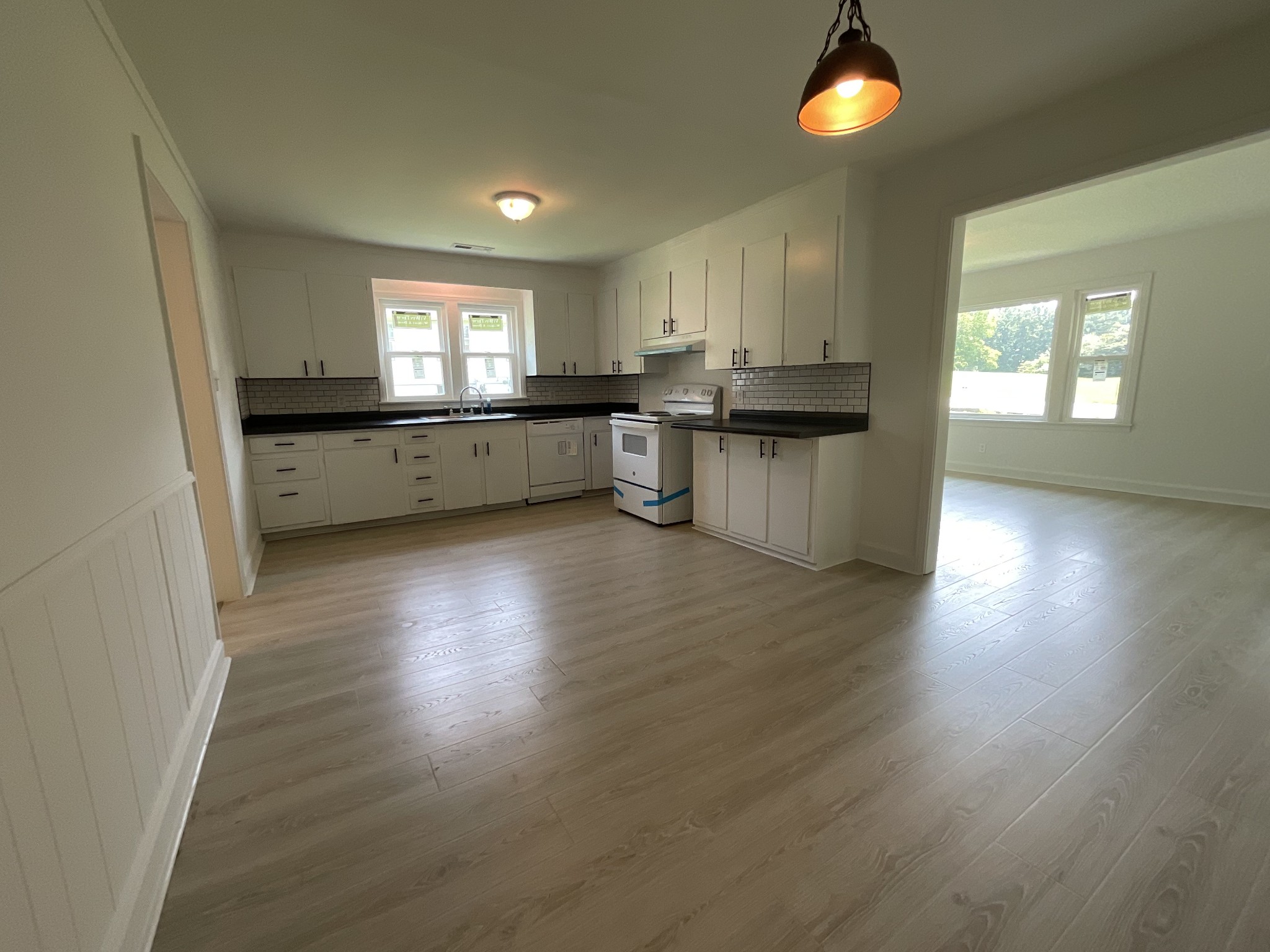 624 Fall River Road Lawrenceburg, TN 38464 - Photo 11 of 22 a kitchen with hard wood floors and white cabinets
