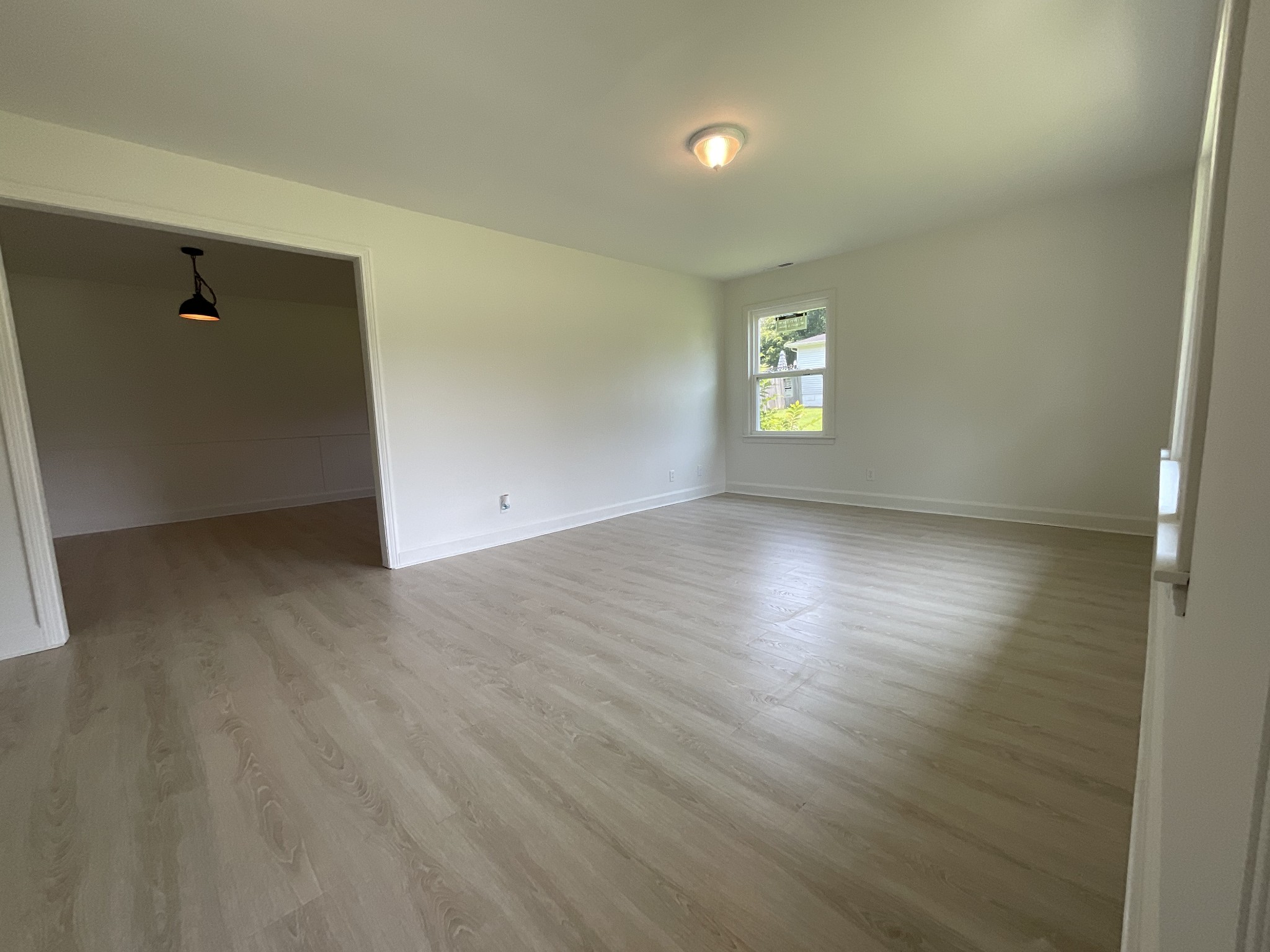 624 Fall River Road Lawrenceburg, TN 38464 - Photo 12 of 22 an empty room with wooden floor and windows