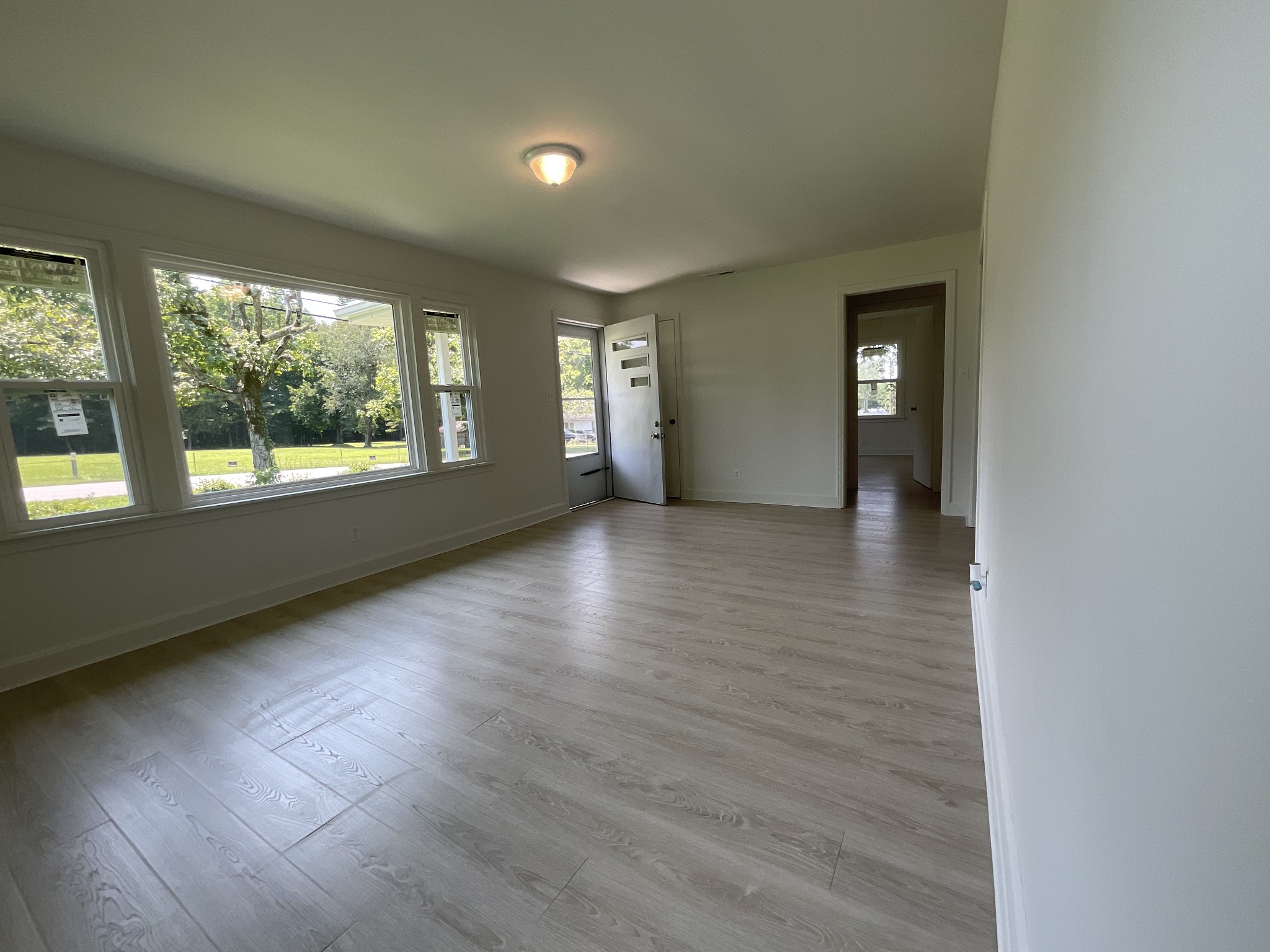 624 Fall River Road Lawrenceburg, TN 38464 - Photo 13 of 22 an empty room with wooden floor and windows