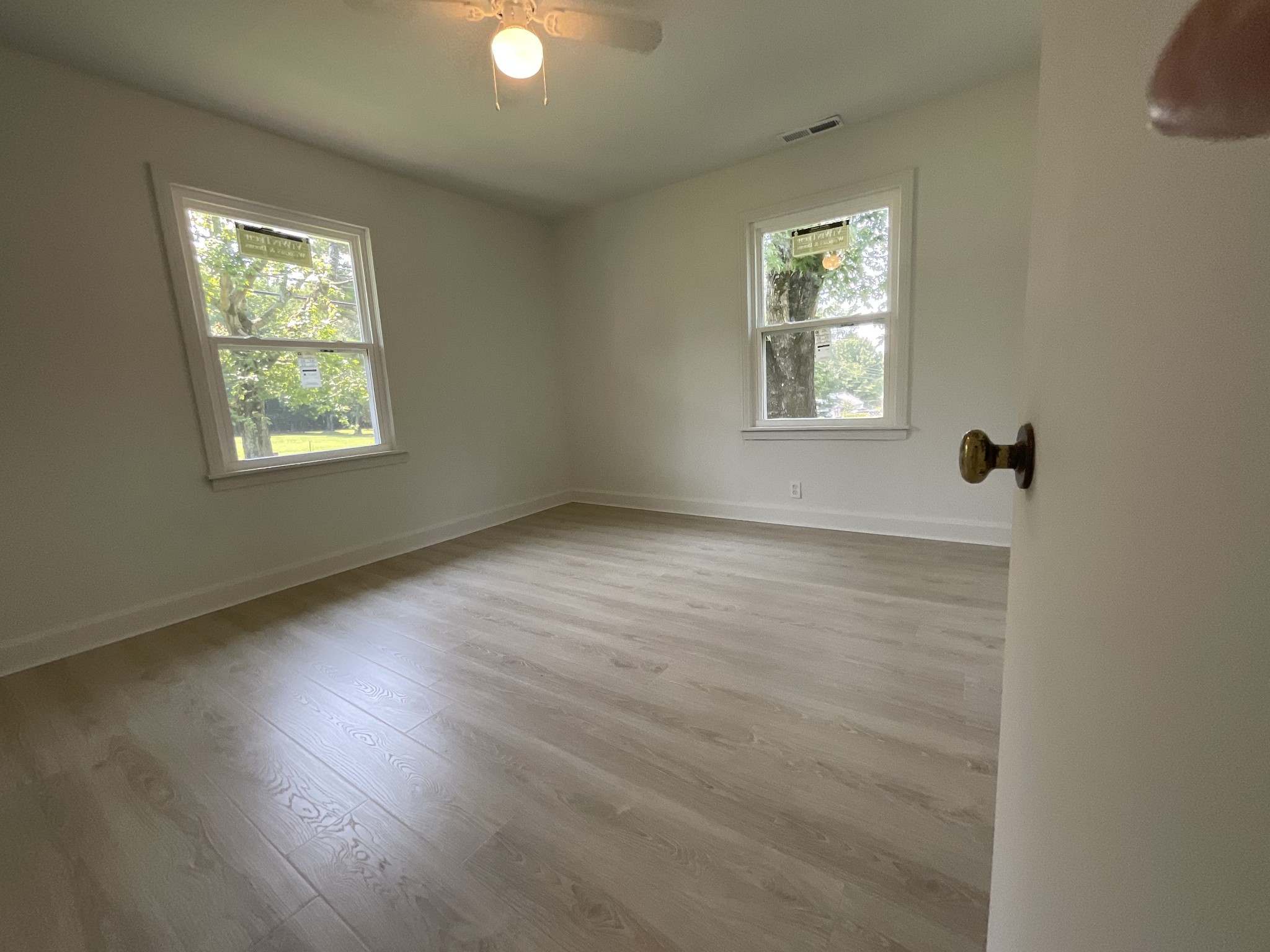624 Fall River Road Lawrenceburg, TN 38464 - Photo 14 of 22 a view of an empty room with wooden floor and a window
