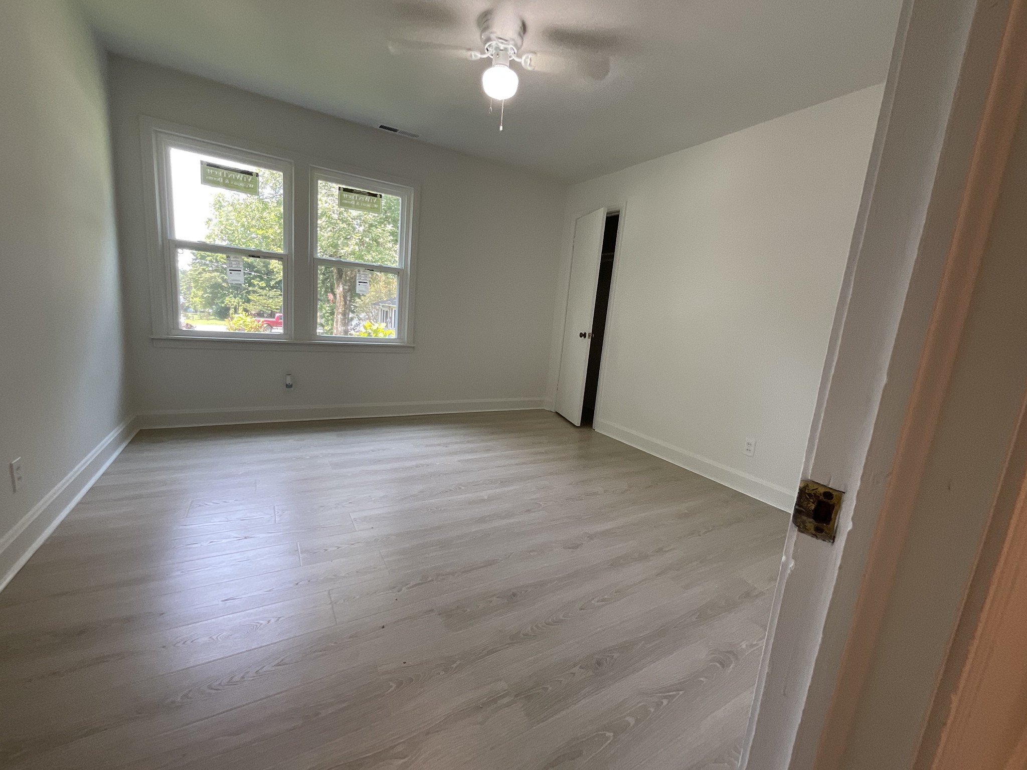 624 Fall River Road Lawrenceburg, TN 38464 - Photo 18 of 22 an empty room with wooden floor and windows