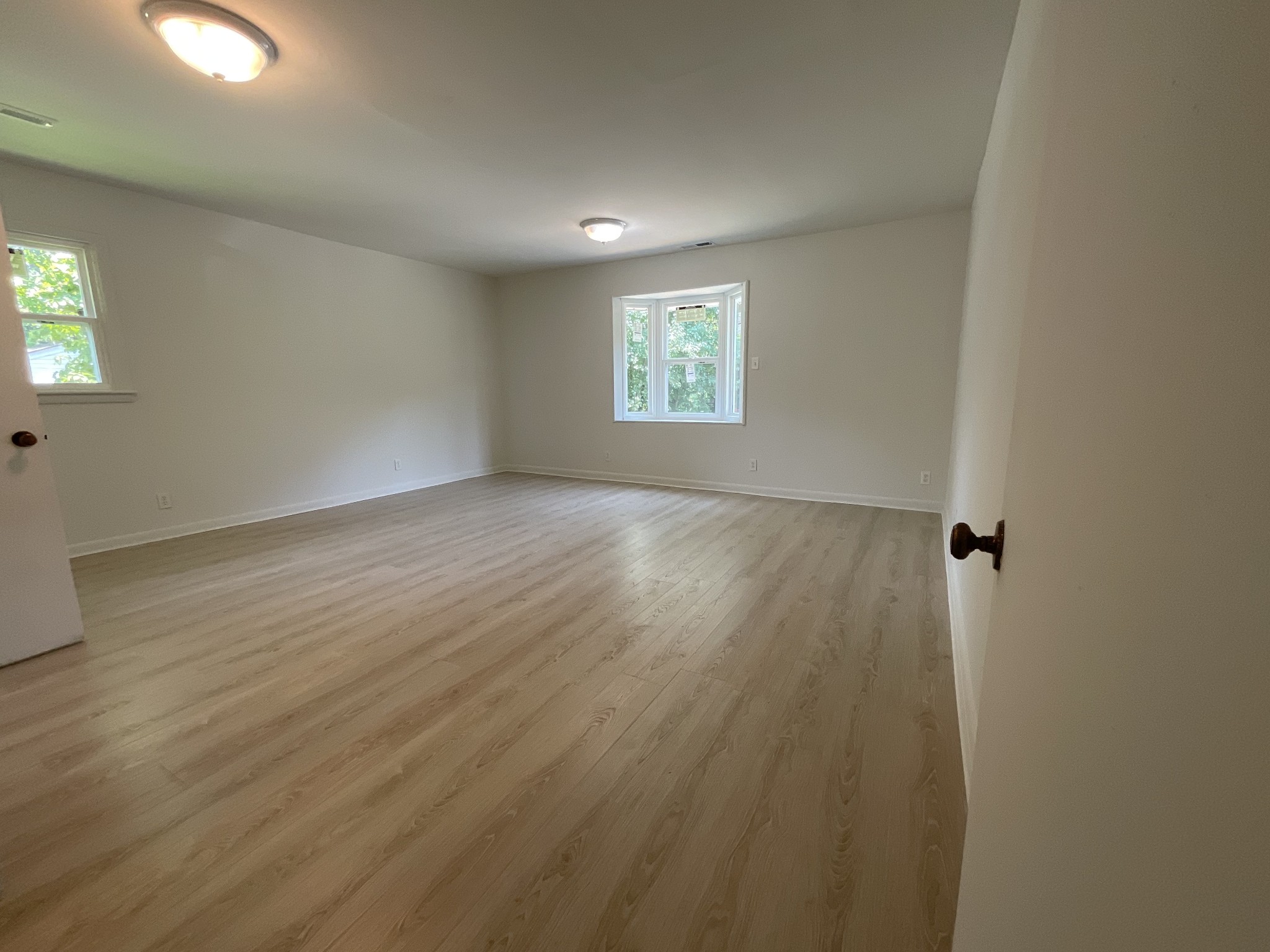 624 Fall River Road Lawrenceburg, TN 38464 - Photo 20 of 22 an empty room with wooden floor and windows