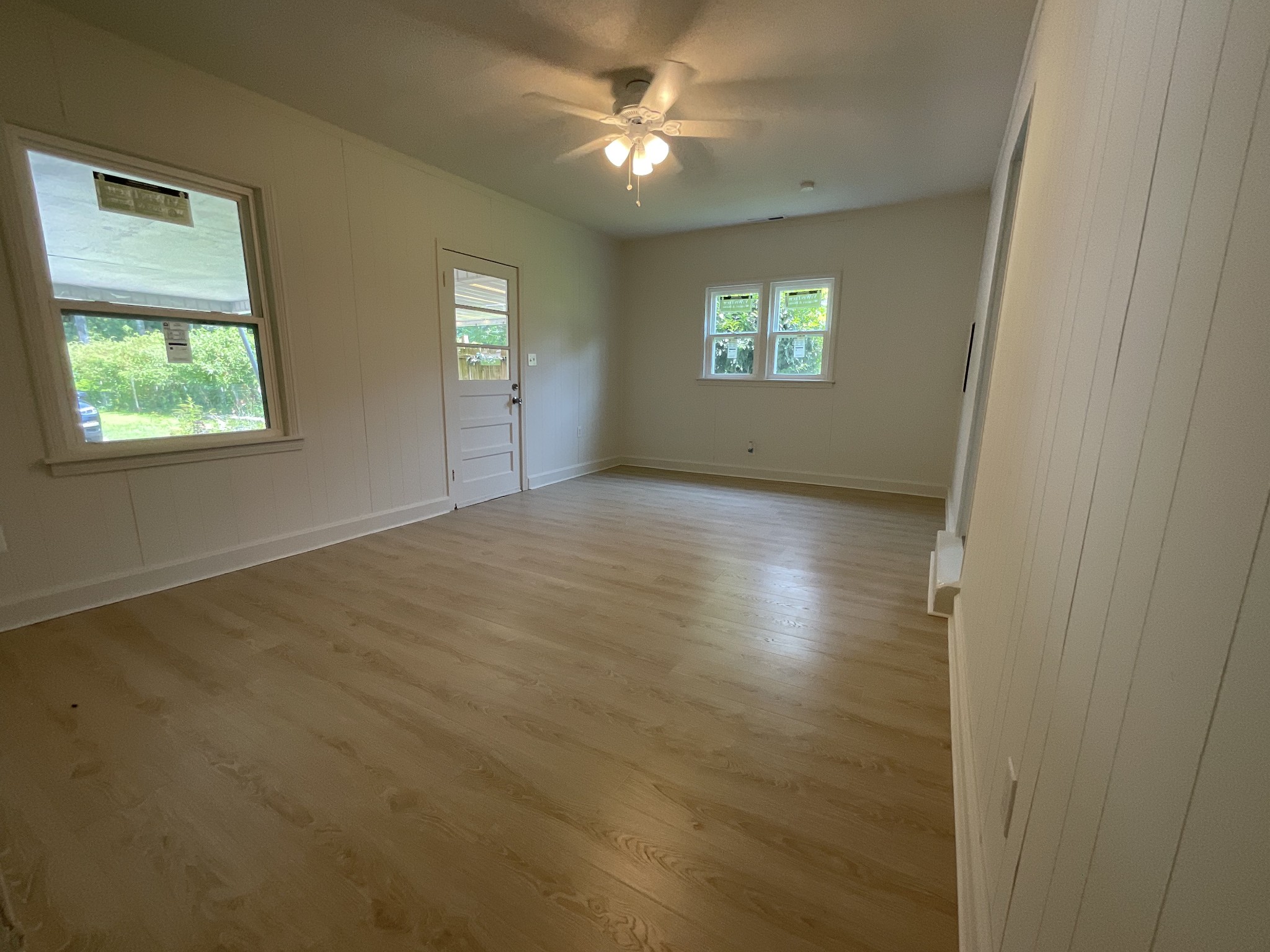 624 Fall River Road Lawrenceburg, TN 38464 - Photo 9 of 22 an empty room with windows and entrance door