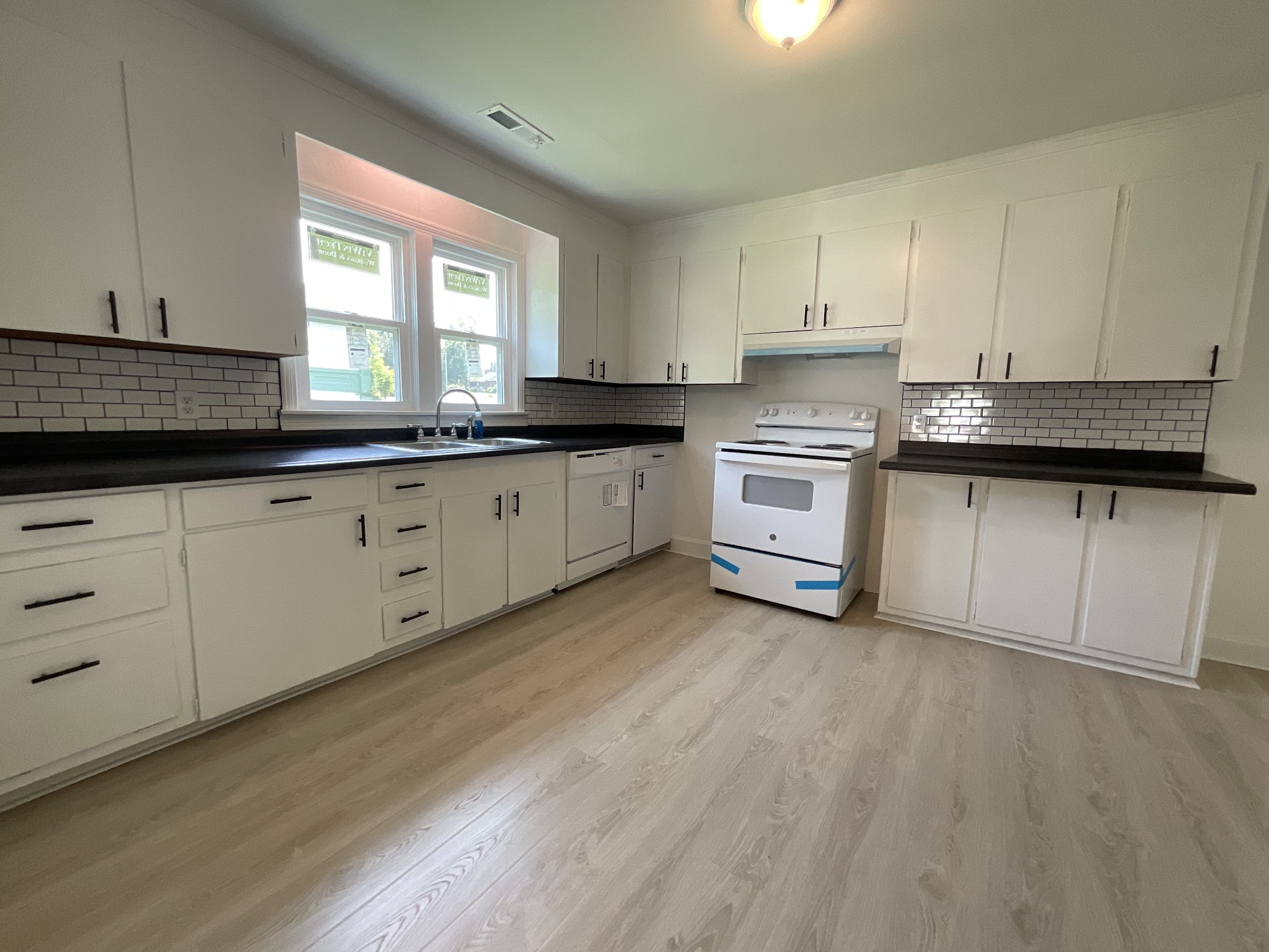 624 Fall River Road Lawrenceburg, TN 38464 - Photo 10 of 22 a kitchen with granite countertop white cabinets and white appliances