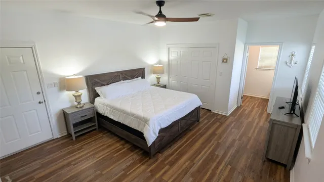 a bedroom with a bed and wooden floor